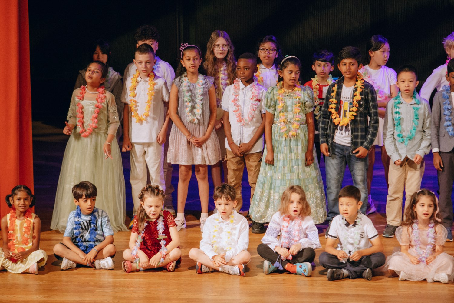 IAS Warsaw students of all ages together on stage at a school event