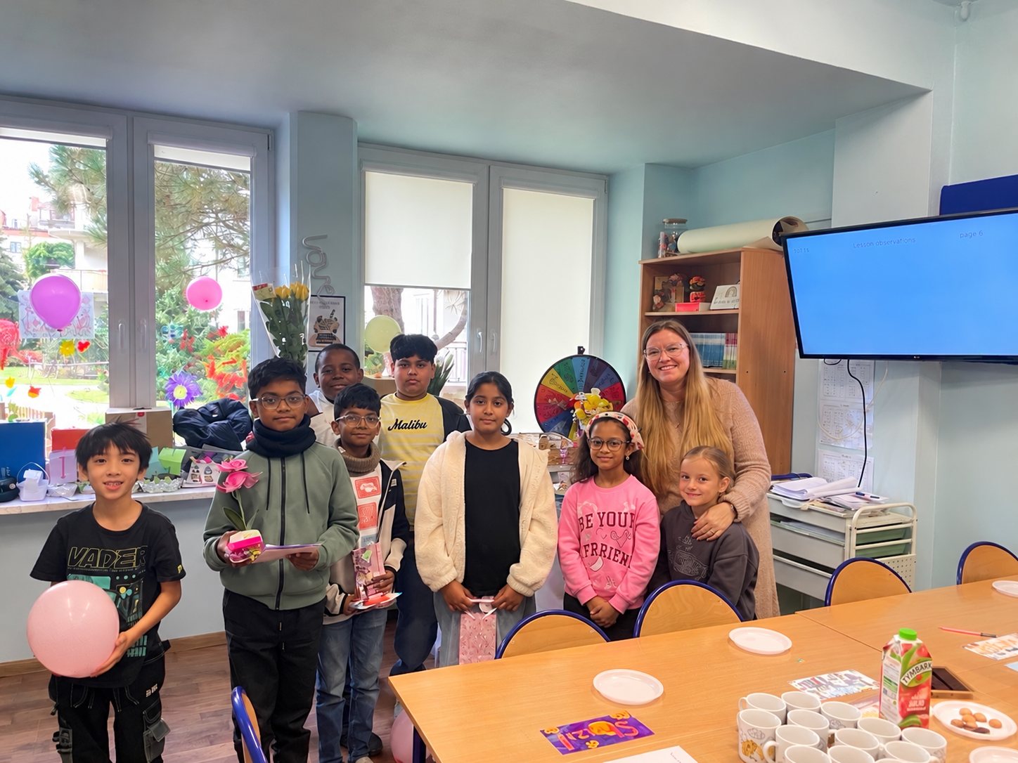 Grade 4 with Ms Julia in their decorated classroom.