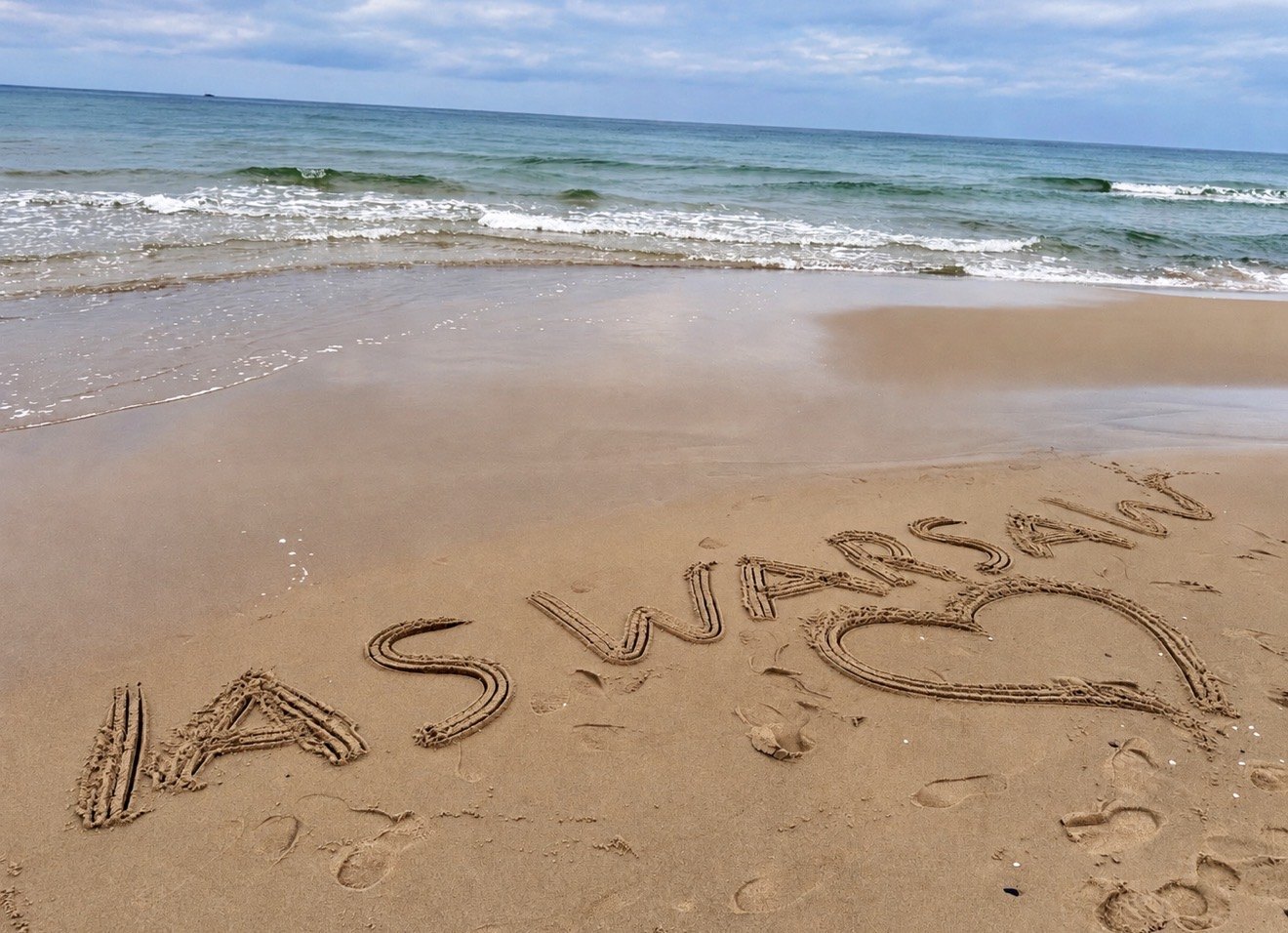 IAS Warsaw written in the sand by the Baltic Sea
