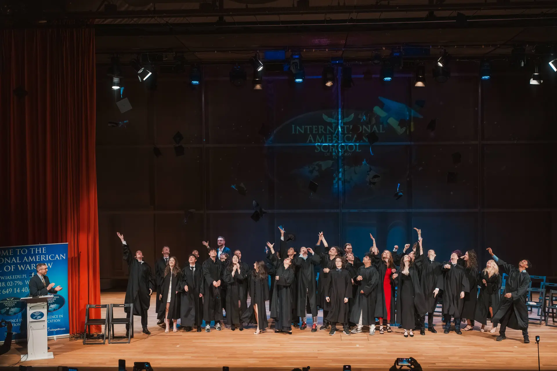 IAS graduates celebrating on stage at the graduation ceremony