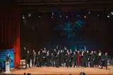 IAS graduates celebrating on stage at the graduation ceremony
