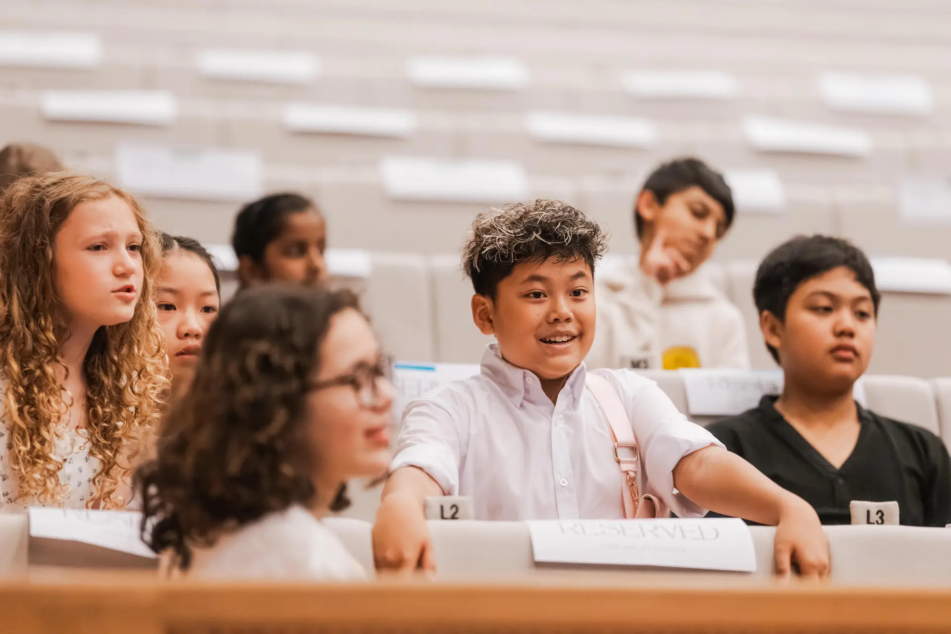 IAS students smiling at a school assembly