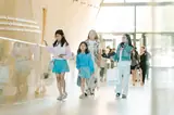 IAS students walking through a bright hall at a school event