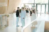 IAS students talking in a bright atrium at a school event