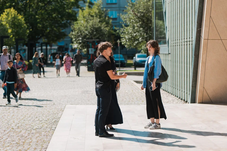 Members of the IAS community talking outside at a school event