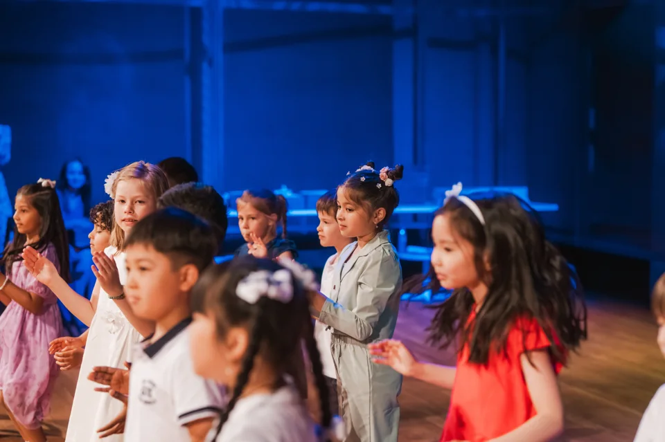 IAS children preparing to perform on stage