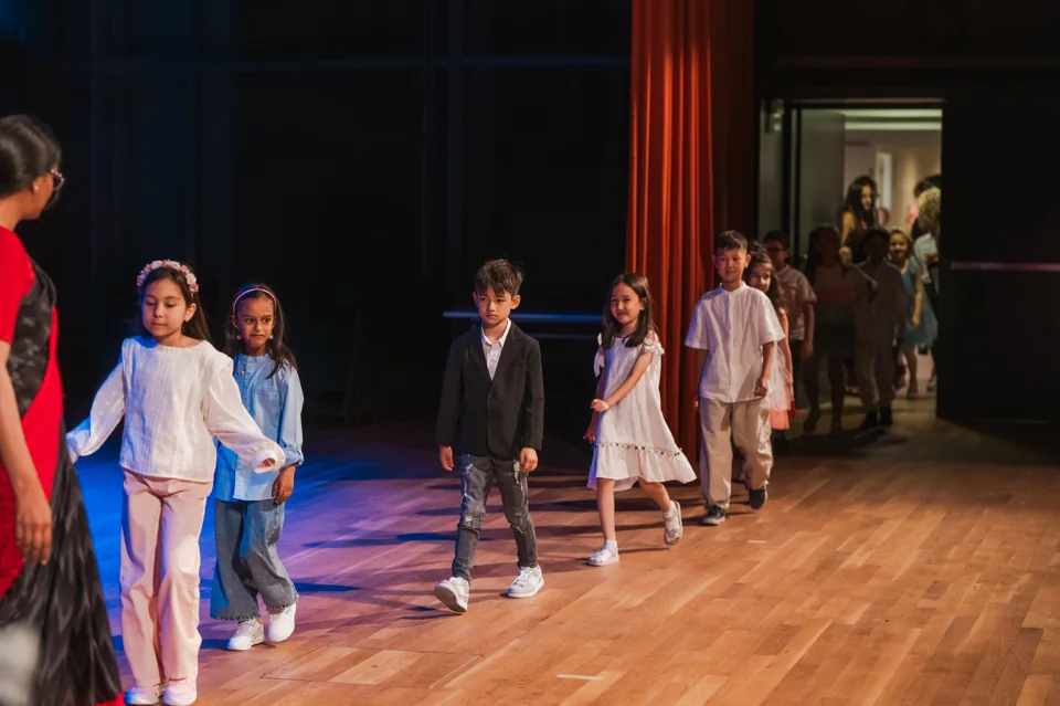 IAS children taking their places on stage